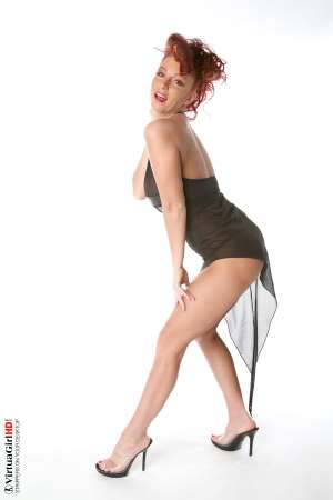 Stripper Picture of Ashley Robbins - Her auburn hair may not be the natural color and it may not match her pubes (when she isn�t completely shaved) but it shows you something about her personality. Ashley doesn�t want to be just another stripper � she wants to capture your imagination and make you one of her fans! Ashley Robbins is Sonia in the Classic cards collection.