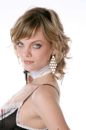 Stripper Picture of Maggie - Maggie is just 22 years old but somehow she has an allure that seems to come from a more classic 1970s or 1960s kind of sex appeal. Many of her fans are older men with more refined tastes. Maggie is like a fine red wine to be savored slowly.