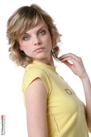 Stripper Picture of Maggie - Maggie is just 22 years old but somehow she has an allure that seems to come from a more classic 1970s or 1960s kind of sex appeal. Many of her fans are older men with more refined tastes. Maggie is like a fine red wine to be savored slowly.