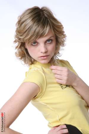 Stripper Picture of Maggie - Maggie is just 22 years old but somehow she has an allure that seems to come from a more classic 1970s or 1960s kind of sex appeal. Many of her fans are older men with more refined tastes. Maggie is like a fine red wine to be savored slowly.