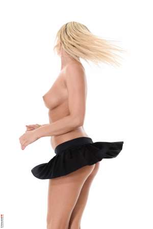 Stripper Picture of Niky - Niky has a rather passionate side which comes out primarily when she's putting on her favorite lingerie. Her gorgeous perky breasts are draped with thin filmy red lingerie while her legs are huged by matching thigh high stockings. Her high heels complete the look and all of that red shows off her pale skin and long blond hair.