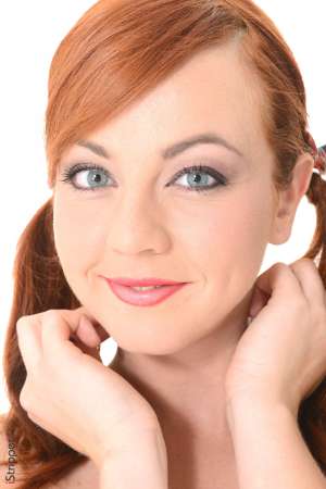 Stripper Picture of Elen Moore - The world loves a red head and we are proud to bring you Elen Moore with her fire engine red hair and her curvaceous body! Elen just graduated from University but she is taking time off to dance and travel the world! Elen is a free spirit at heart and she loves exploring all aspects of her sexuality. Elen has traveled to more than 20 countries and she is proud to say she has had a lover in each and every one! Bisexual and outgoing Elen is a true exhibitionist and she can't wait to perform for you!