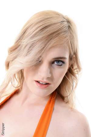 Stripper Picture of Carly Rae - Are you ready for some sexy fun with a tattooed dominatrix? Then get ready to meet Carly Rae the 23 year old blonde bombshell from Manchester UK. Carly describes herself as having a rather dominant personality. She is by no means a wallflower. Carly likes to be in charge and have her voice heard. She also likes to have her body admired by all her adoring fans which is why she went into exotic dancing. When she's not on stage Carly studies up on BDSM play which she incorporates into her personal life. She thinks sex should be fun and she enjoys power play that establishes a dominant and submissive. She tells us that she has an extensive collection of whips and leather corsets at home and that she is currently learning knot tying techniques to improve her bondage play.