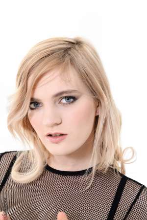 Stripper Picture of Carly Rae - Are you ready for some sexy fun with a tattooed dominatrix? Then get ready to meet Carly Rae the 23 year old blonde bombshell from Manchester UK. Carly describes herself as having a rather dominant personality. She is by no means a wallflower. Carly likes to be in charge and have her voice heard. She also likes to have her body admired by all her adoring fans which is why she went into exotic dancing. When she's not on stage Carly studies up on BDSM play which she incorporates into her personal life. She thinks sex should be fun and she enjoys power play that establishes a dominant and submissive. She tells us that she has an extensive collection of whips and leather corsets at home and that she is currently learning knot tying techniques to improve her bondage play.