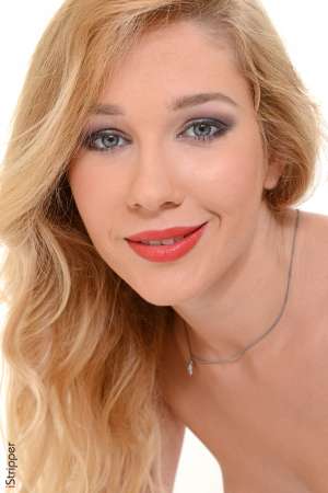 Stripper Picture of Genevieve Gandi - Genevieve Gandi is making her Diva debut with us and we know you are going to love what she's putting out there. This 23-year-old blonde beauty from Russia is a sexy bombshell that prides herself on being a total exhibitionist. Genevieve loves to be in the spotlight always. Whether she is out with friends at a club or performing on stage she likes all eyes to be on her. She is a true performer and she tells us that stripping is the perfect profession for her. Genevieve has always liked to be in the spotlight. She grew up performing for anyone who would watch and actually considered going to University for the performing arts. But a dirty dancing competition got in the way of that. While away on Holiday Genevieve joined the competition with a girlfriend and won! As she left the stage a club owner in the audience told her she should think about dancing professionally and a new career was born! Like any 23-year-old hottie Genevieve lives very much in the now. She considers herself a bit of a party-girl and still enjoys staying out until the sun comes up hitting all the hot clubs. She also enjoys traveling with friends dancing obviously shopping and role playing in bed!