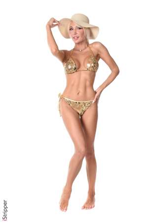 Stripper Picture of Bad Barbie - Here is Bad Barbie from Russia. Barbie's beauty is so incredible that it makes her almost unreal... She has slim long legs a perfect tanned skin an angel face and amazing deep blue eyes... She's a professional dancer and teaches belly dancing & gogo dancing. she is very interested in naturopathy and devotes a lot of time to creating her own beauty products based solely on natural products. She is a sweet and empathic woman a treat to work with!